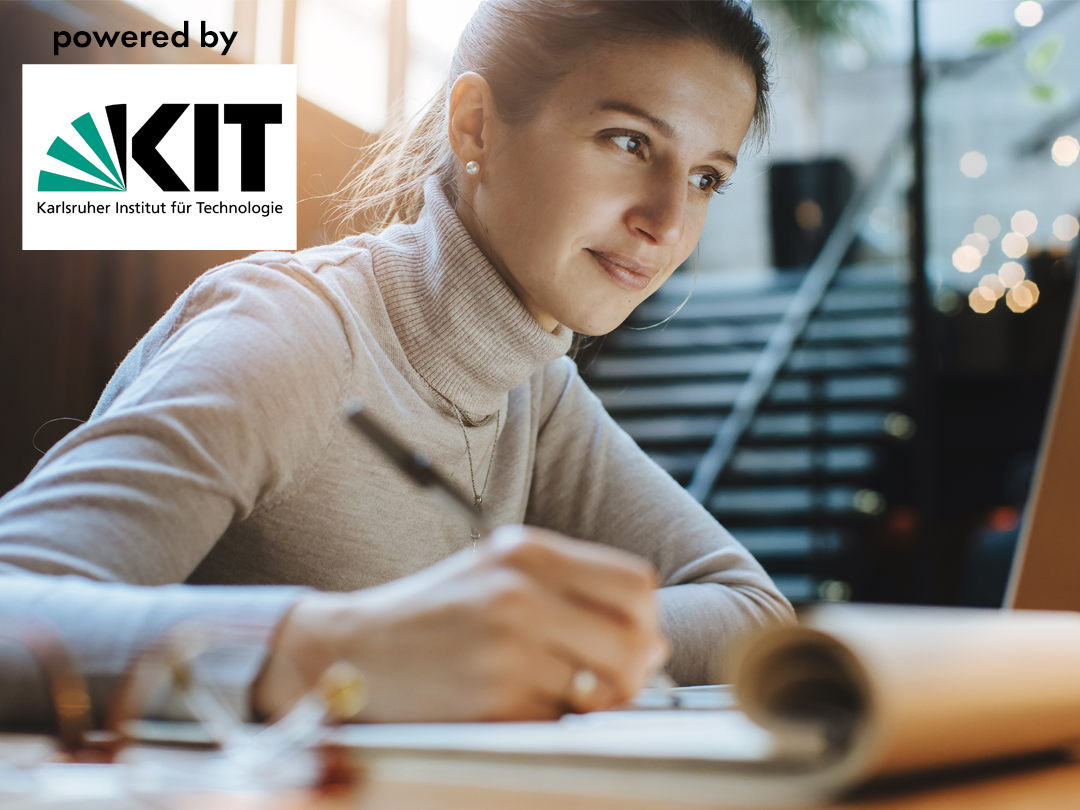 Woman writing in a notebook at a desk, with the KIT (Karlsruher Institut für Technologie) logo in the top-left corner, indicating sponsorship/partnership.