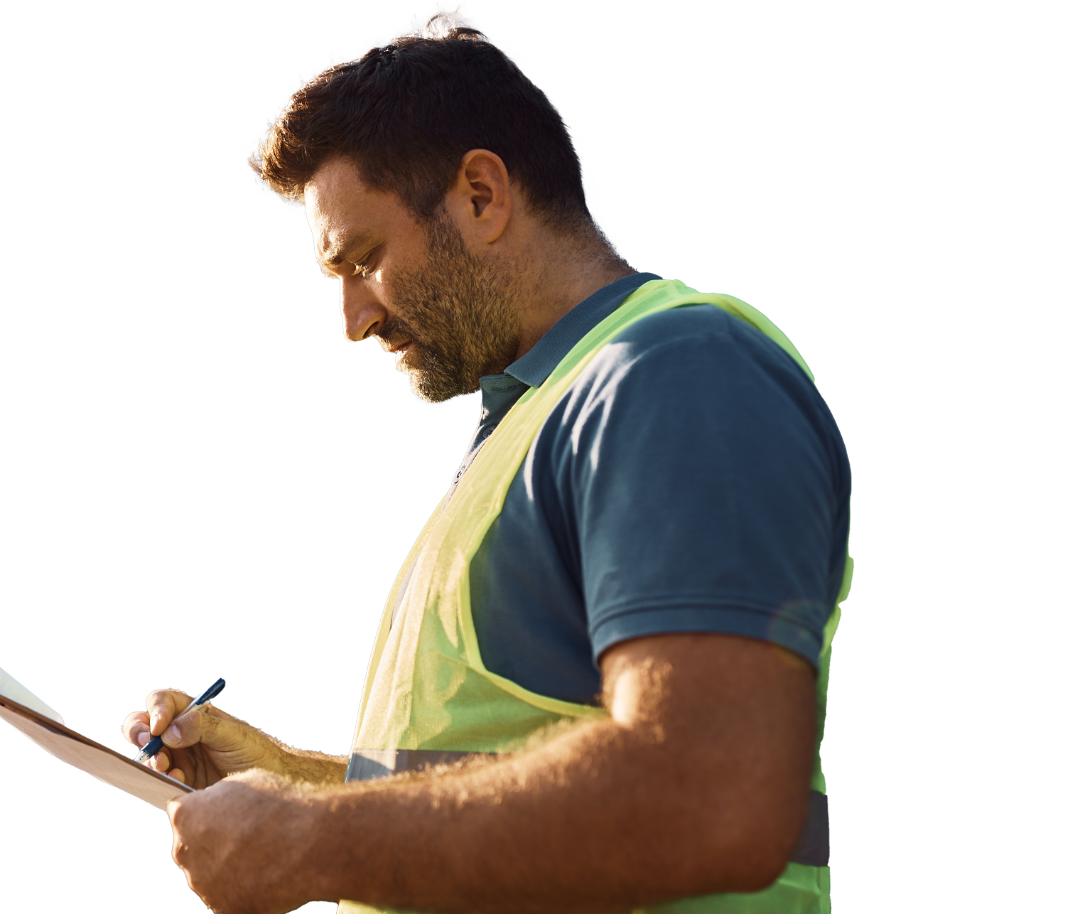 Side view of a construction worker in a neon safety vest writing on a clipboard.